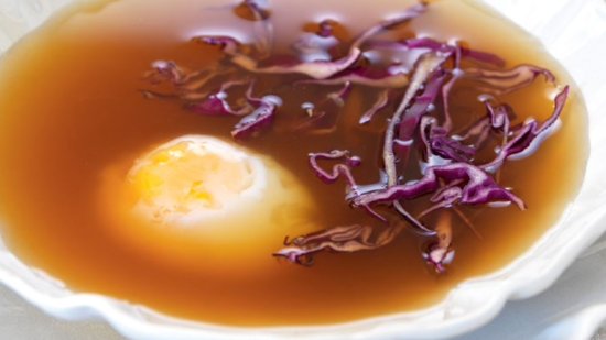 Huevo a baja temperatura en caldo de jamón y juliana de coles